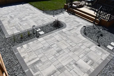 Barkman Broadway paver patio in sterling with charcoal border completed by Genesis Interlocking & Custom Landscaping In Winnipeg