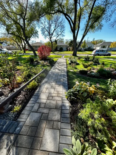 Barkman Verano paver sidewalk with perennial gardens completed by Genesis Interlocking & Custom Landscaping in Winnipeg