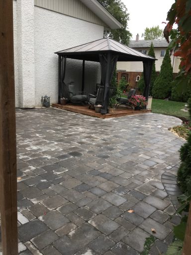 Barkman Roman paver patio in Sierra grey completed by Genesis Interlocking & Custom Landscaping in Winnipeg