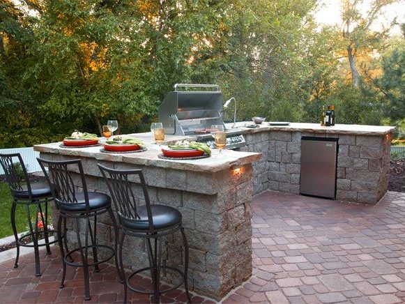 Outdoor Kitchen with Bar Top and Interlocking Paving Stone Patio