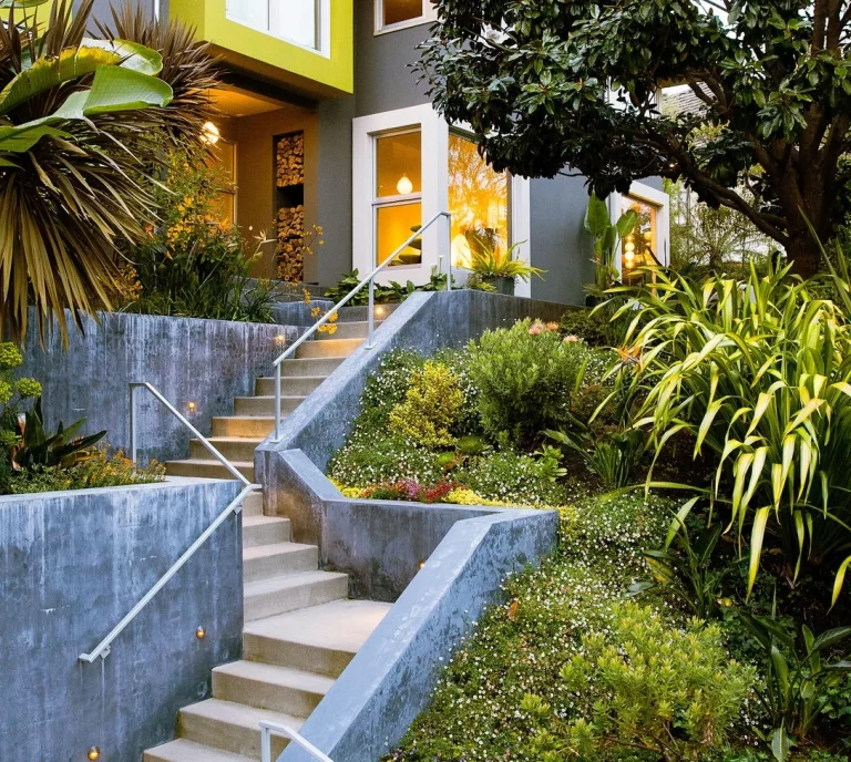 Front entrance retaining walls, steps & railings with tropical landscaping 