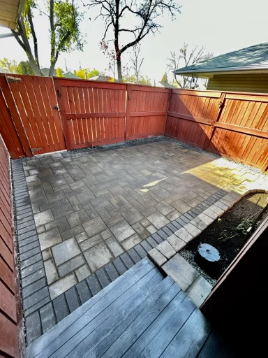Barkman Verano paver patio with charcoal border completed by Genesis Interlocking & Custom Landscaping in Winnipeg