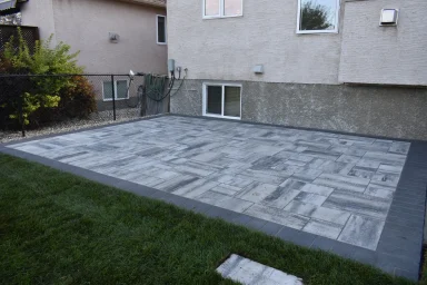 Barkman Broadway paver patio in sterling with charcoal border completed by Genesis Interlocking & Custom Landscaping in Winnipeg