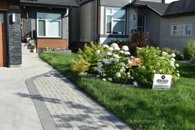 Barkman Holland paver driveway extension and front flower garden completed by Genesis Interlocking & Custom Landscaping in Winnipeg