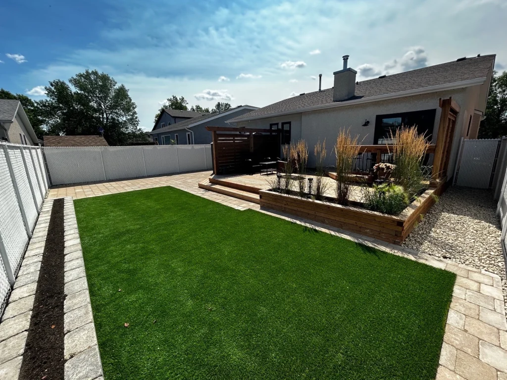 Backyard hardscaping & landscaping installation - artificial turf, roman pavers, quarry stone flower garden, pressure treated deck and garden box