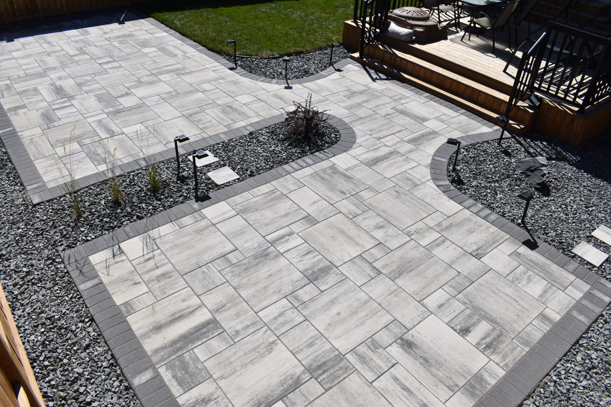 Genesis Interlocking & Custom Landscaping backyard hardscaping installation - Barkman Broadway slabs with border & landscaping