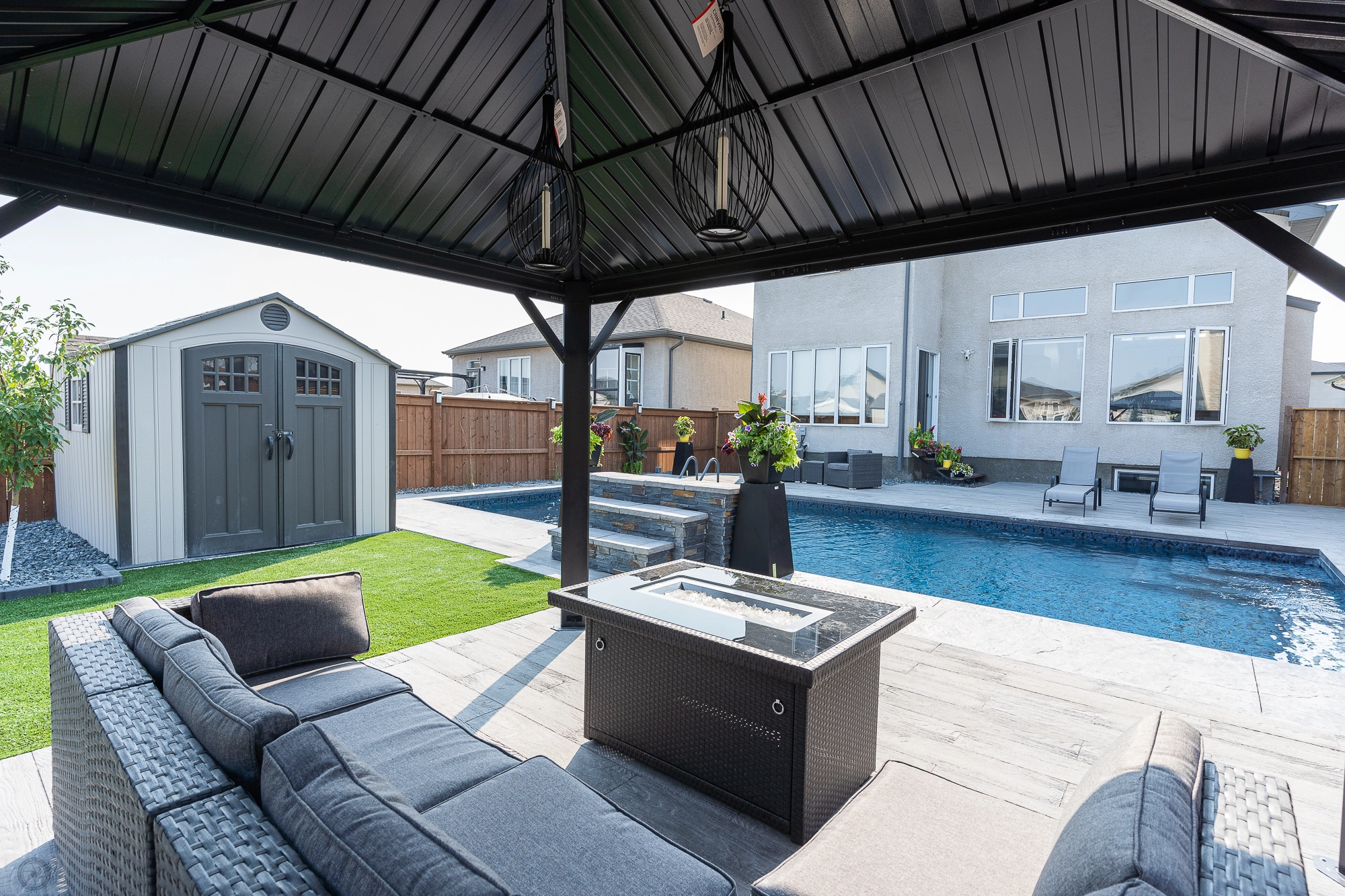 Genesis Interlocking & Custom Landscaping backyard pool project - Paving stone patio / pool deck, artificial turf, gazebo