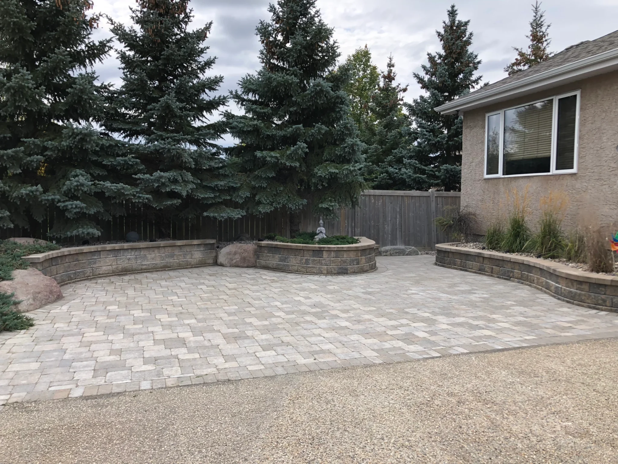 Backyard Barkman Roman pavers patio installation - Landscaping Gallery Winnipeg