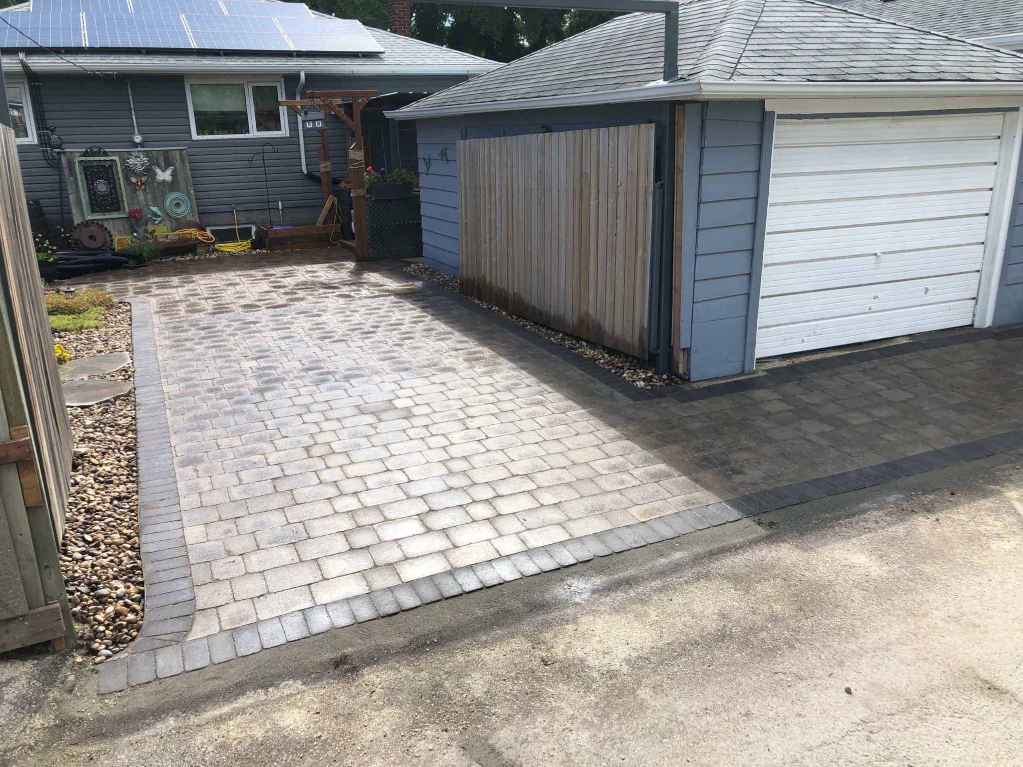 Roman paver parking pad & garage approach installation