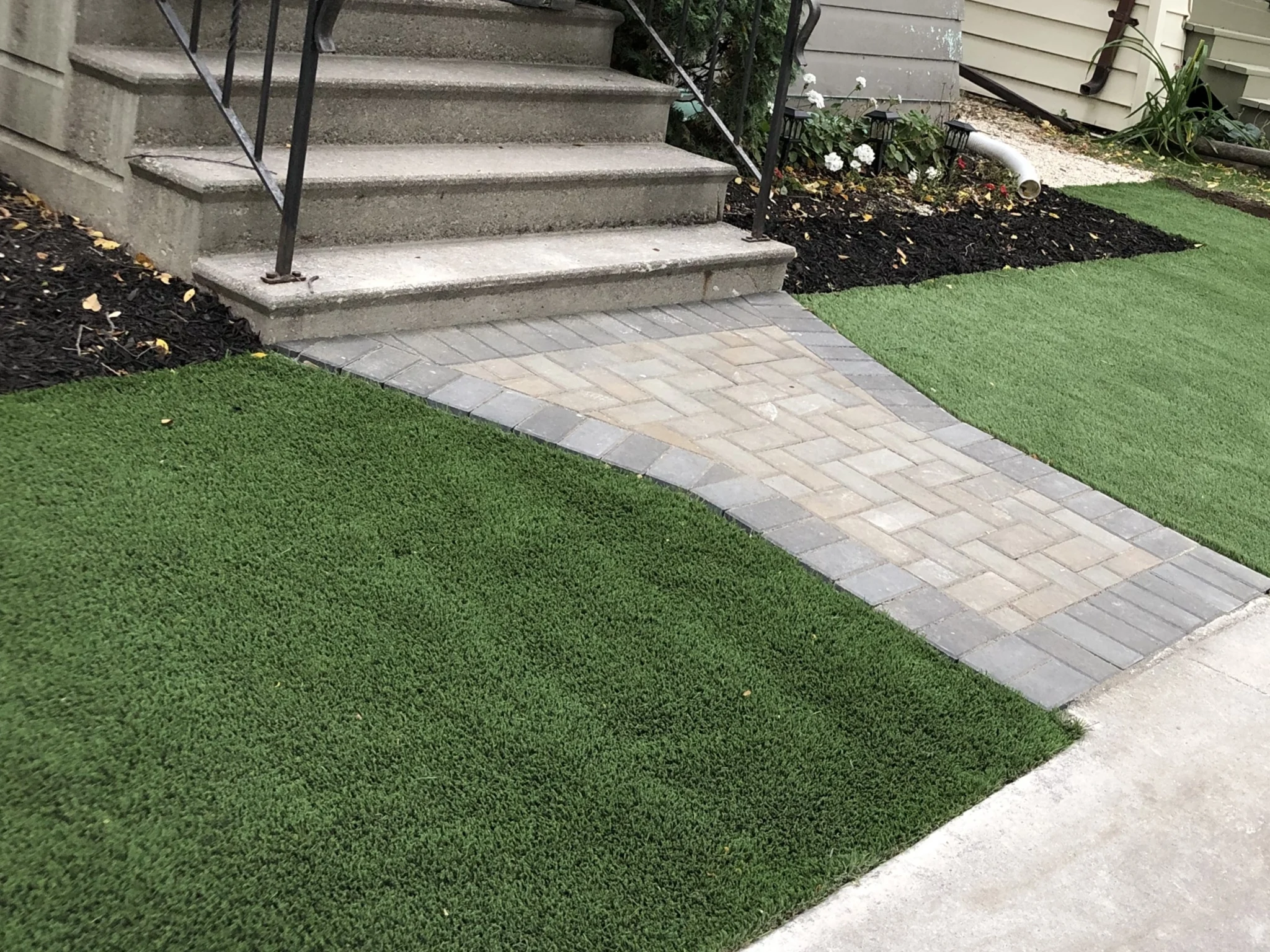 Barkman Holland paver front entrance sidewalk installation with artificial turf - Driveways and Sidewalks Winnipeg 