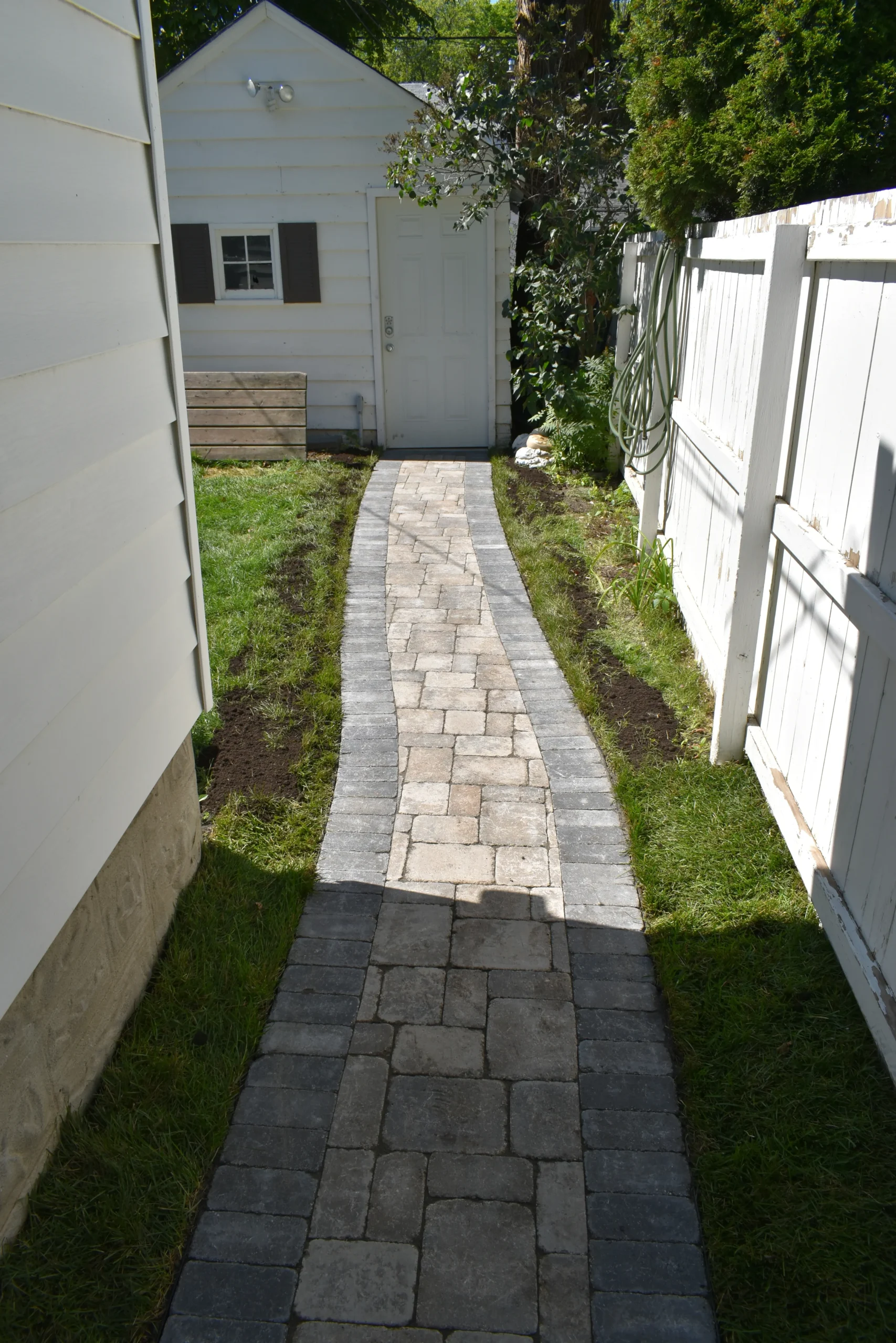 Backyard Roman paver sidewalk installation - Winnipeg Landscaping
