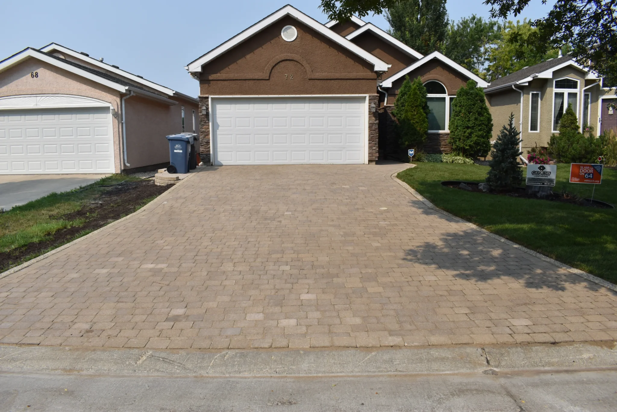 Roman paver driveway installation with concrete curbing completed in Winnipeg Manitoba