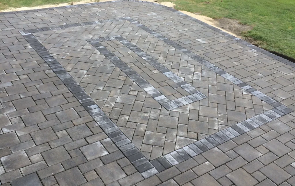 Backyard patio install - Barkman verano pavers with custom inlay