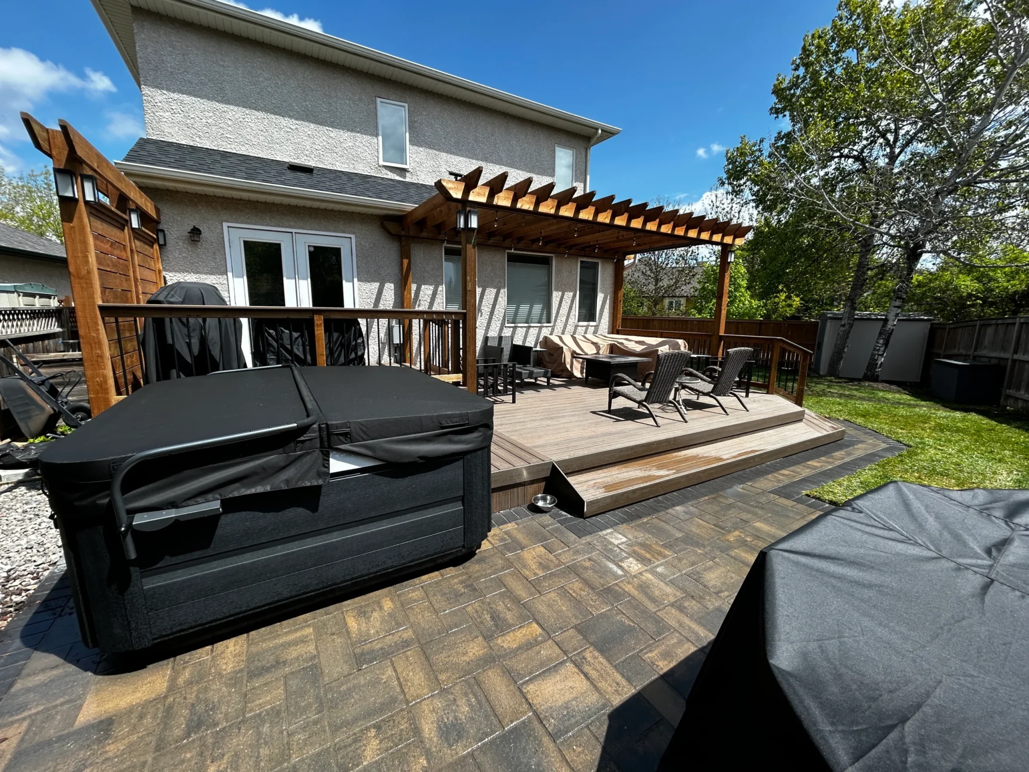 Backyard Barkman verano paver patio install, composite deck & pergola - Winnipeg landscaping professionals