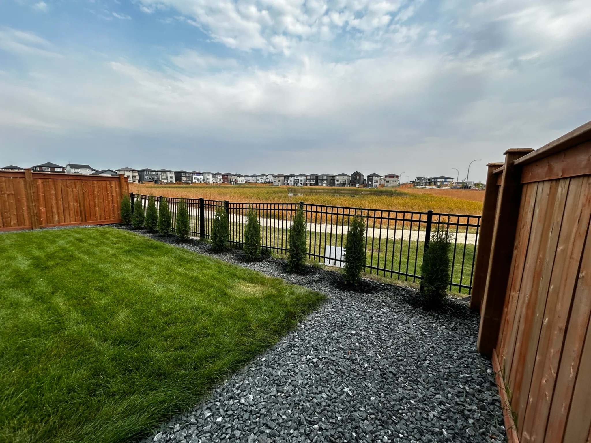 Cedar privacy fence installation with black granite - Winnipeg landscaping 