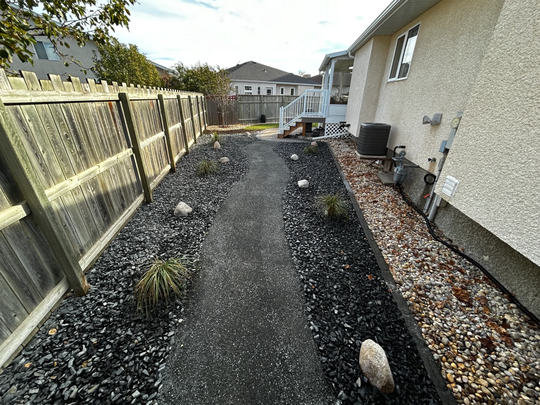 Side yard landscaping - Decorative rock, plants & boulders