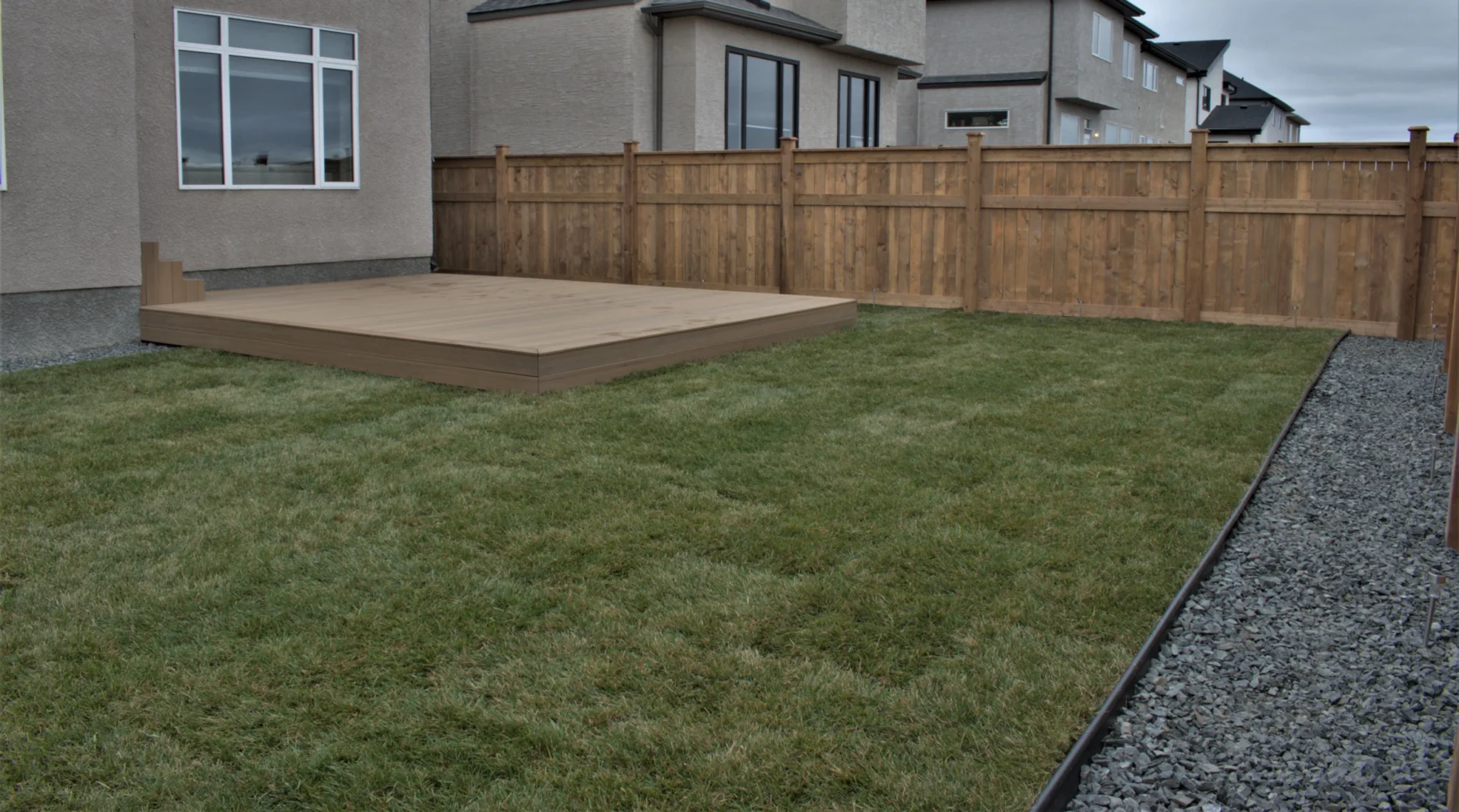 Backyard sod & decorative rock - black granite installation 