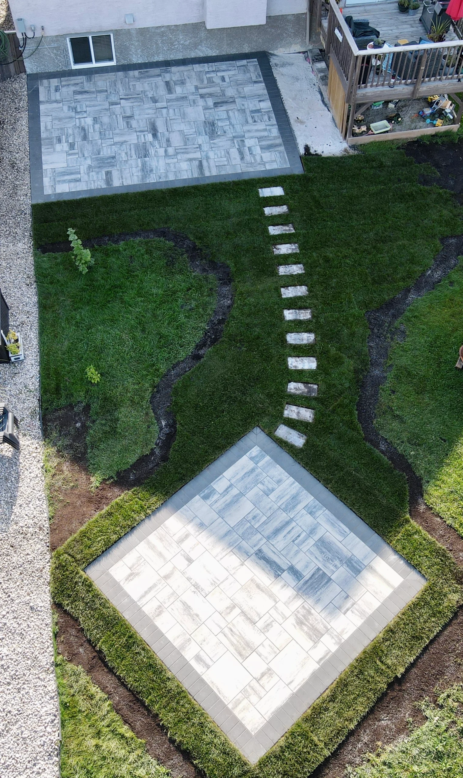 Genesis Interlocking & Custom Landscaping backyard hardscaping installation - Barkman Broadway slabs with border & landscaping