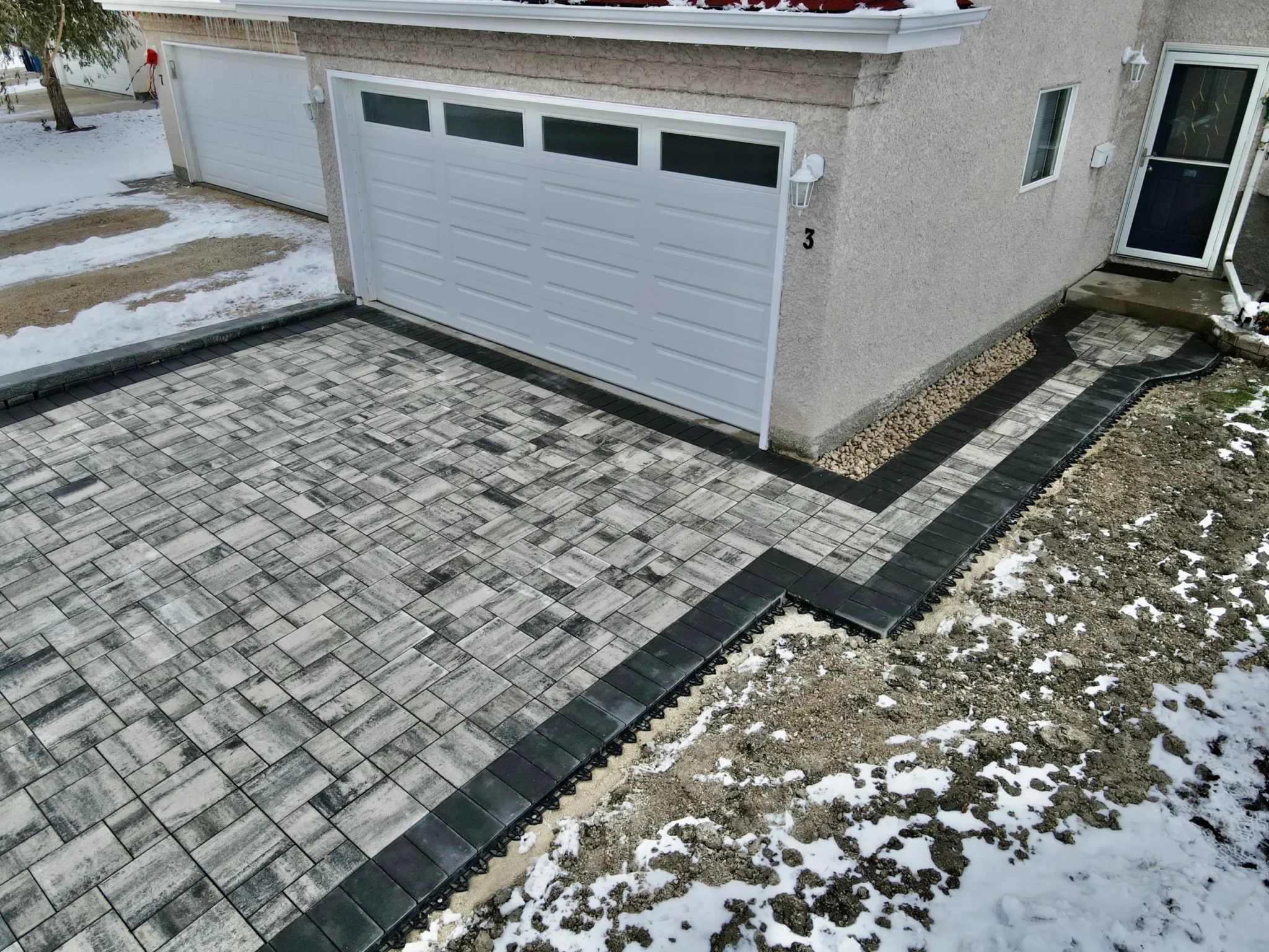 Barkman Broadway slab driveway installation - Completed in Winnipeg Manitoba by Genesis Interlocking & Custom Landscaping - Driveways and Sidewalks Winnipeg 