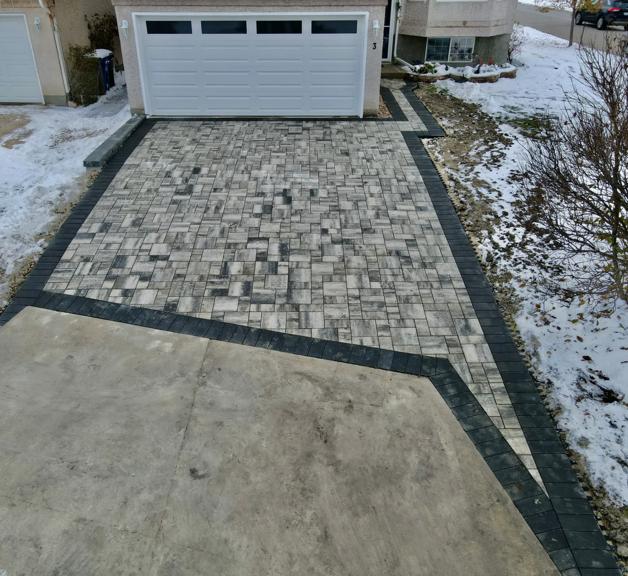 Barkman Broadway slab driveway installation - Completed in Winnipeg Manitoba by Genesis Interlocking & Custom Landscaping - Driveways and Sidewalks Winnipeg 