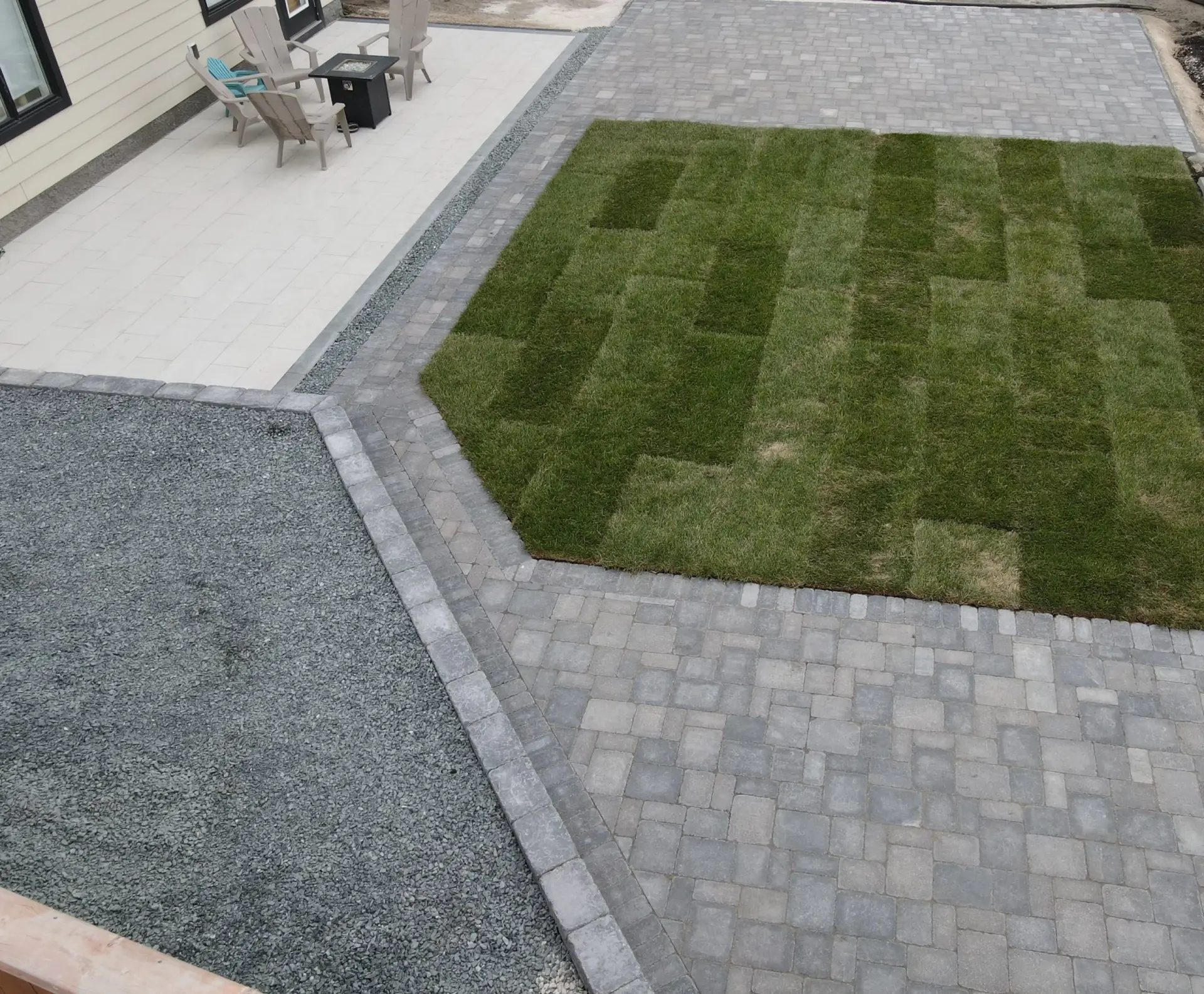 Backyard interlocking patio install - Barkman roman pavers, quarry stone wall, sod & black granite