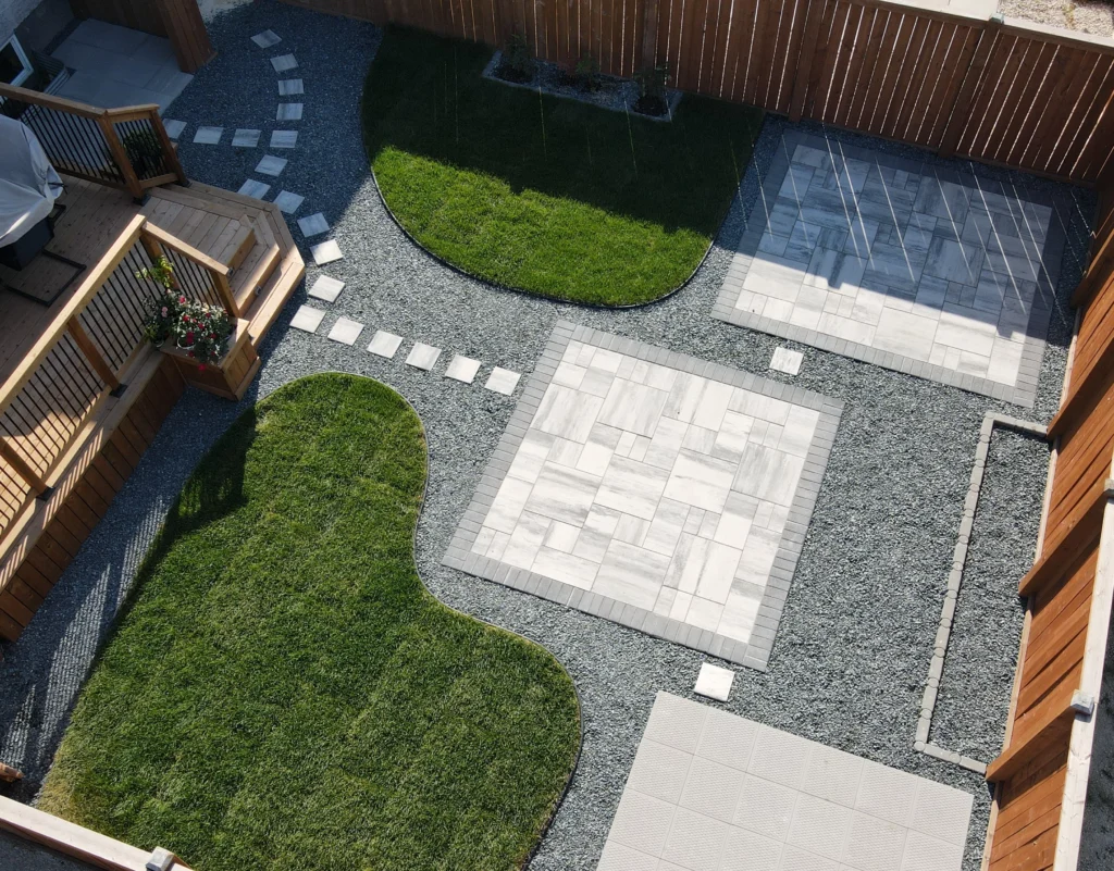 Genesis Interlocking & Custom Landscaping backyard hardscaping installation - Barkman Broadway slabs with border & landscaping