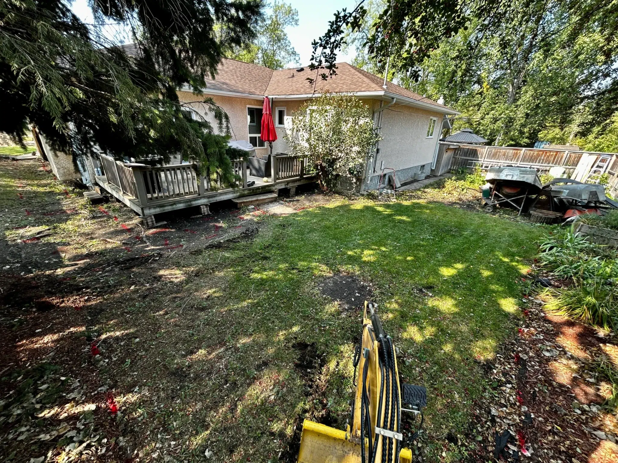 Backyard grading and levelling for proper water run off in Winnipeg Manitoba