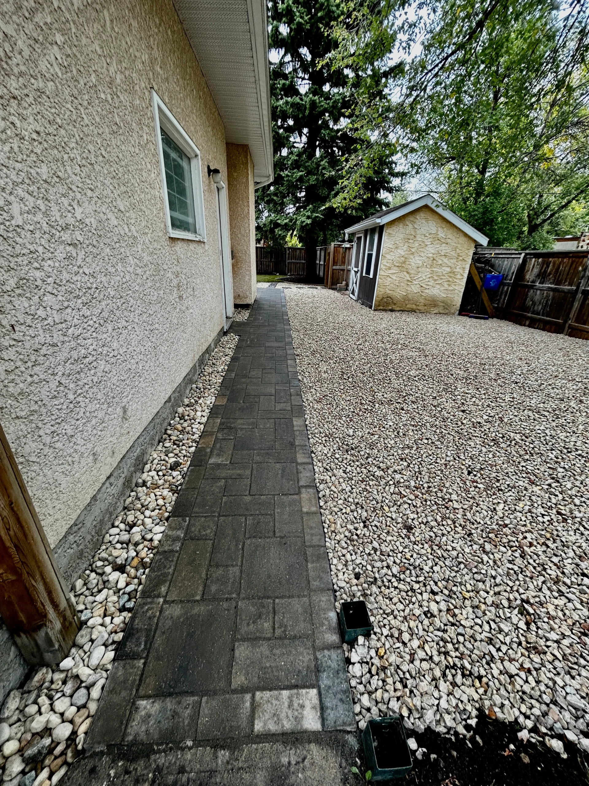 Barkman Verano Paver sidewalk installation - side yard landscaping with decorative rock