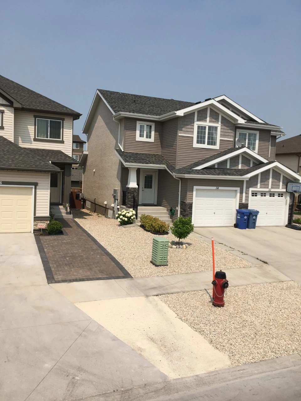 Front driveway Holland paver installation - Winnipeg Landscaping