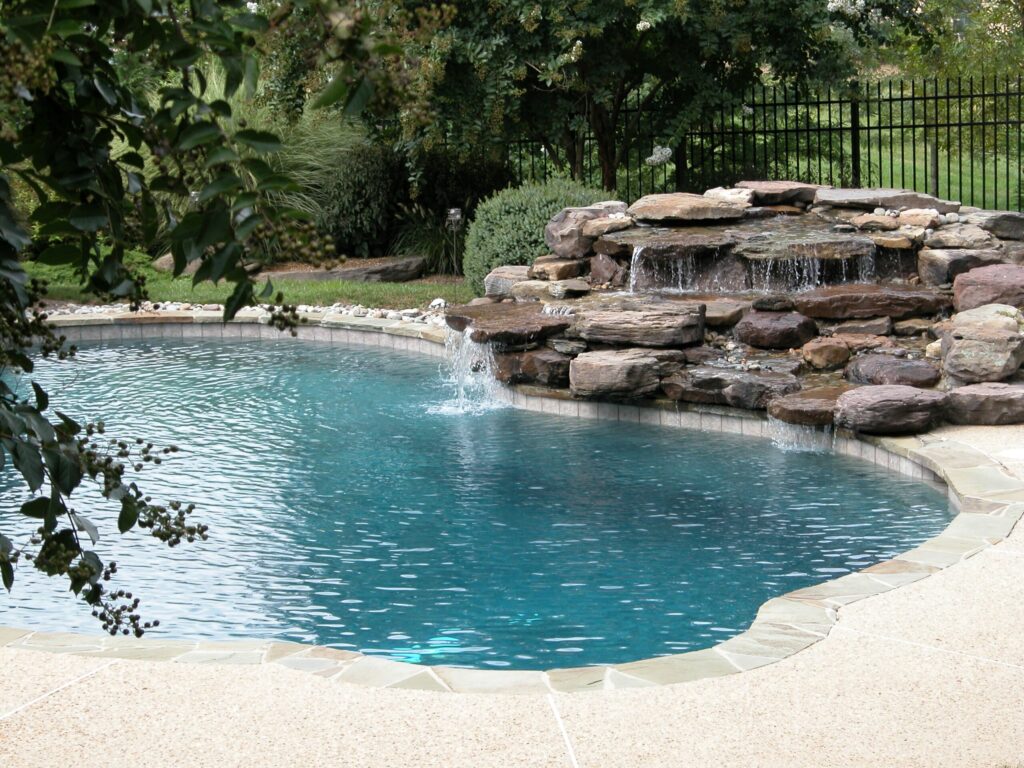 Backyard pool installation waterfall with natural stone 