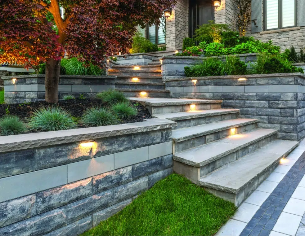 Front yard retaining wall flower garden with steps and custom landscaping and low voltage lighting