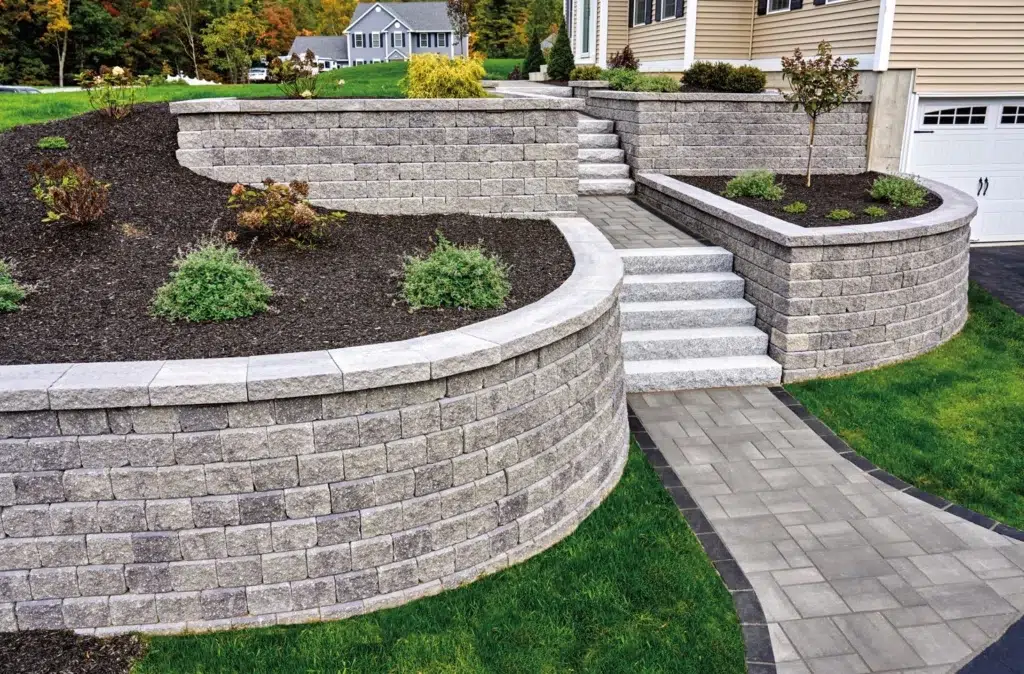 Front yard retaining wall flower garden with steps and custom landscaping