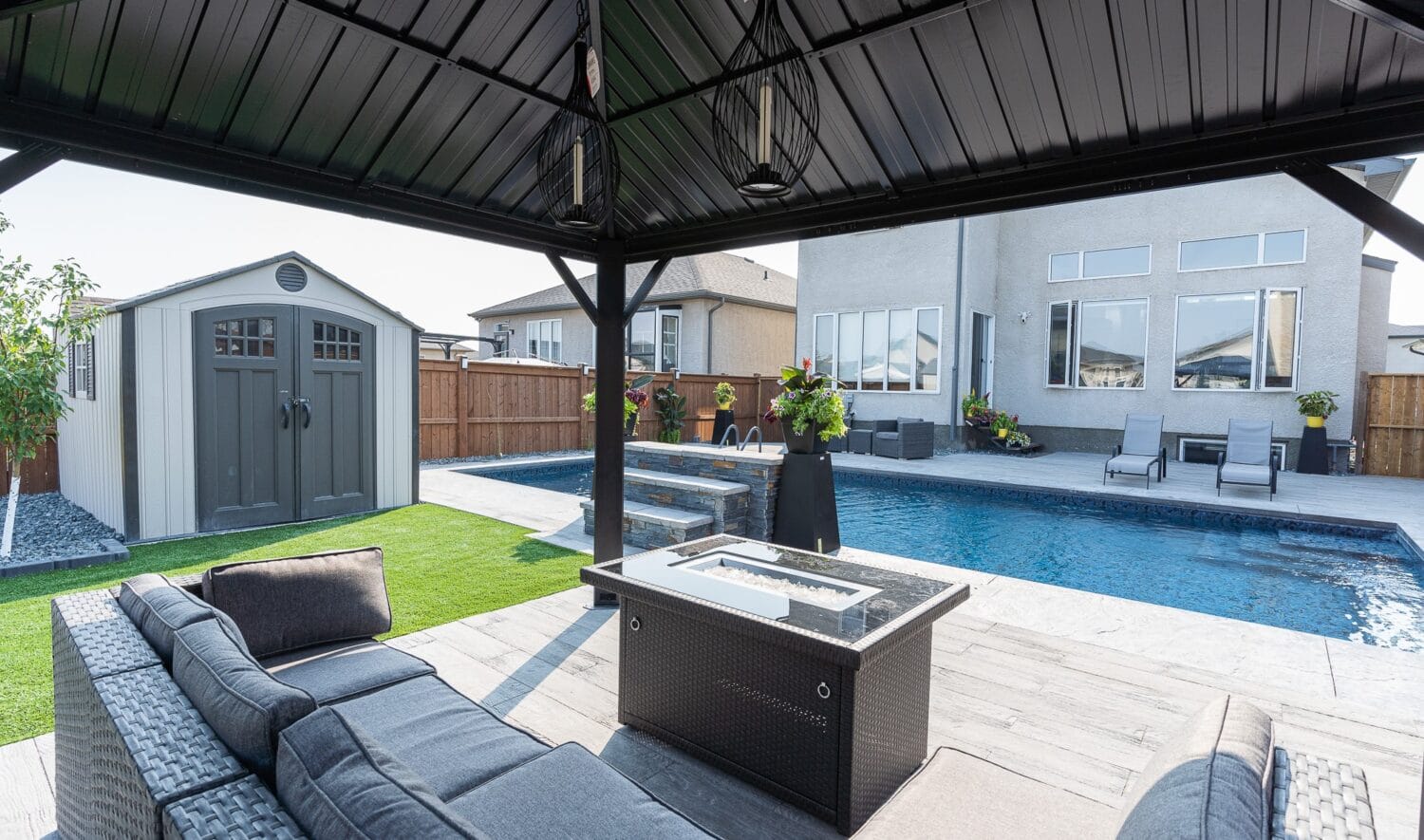 Genesis Interlocking & Custom Landscaping backyard pool project - Paving stone patio / pool deck, artificial turf, gazebo