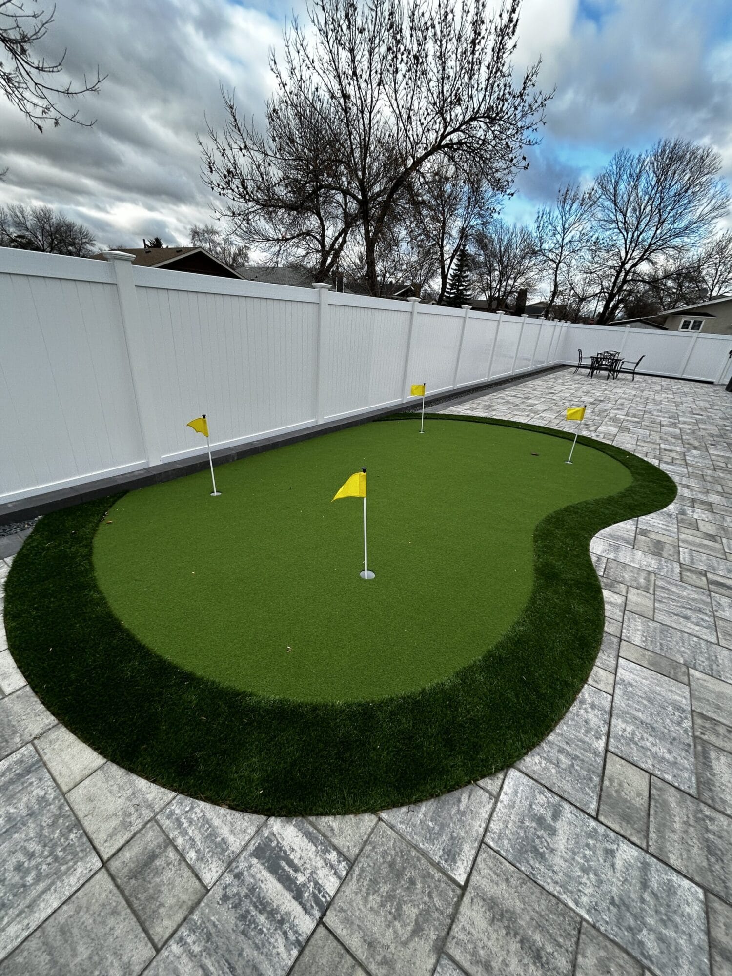 Artificial turf putting green installation by Genesis Interlocking & Custom Landscaping in Winnipeg Manitba
