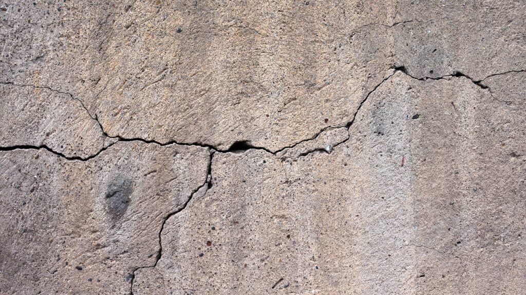 Cracked concrete driveway and sidewalk
