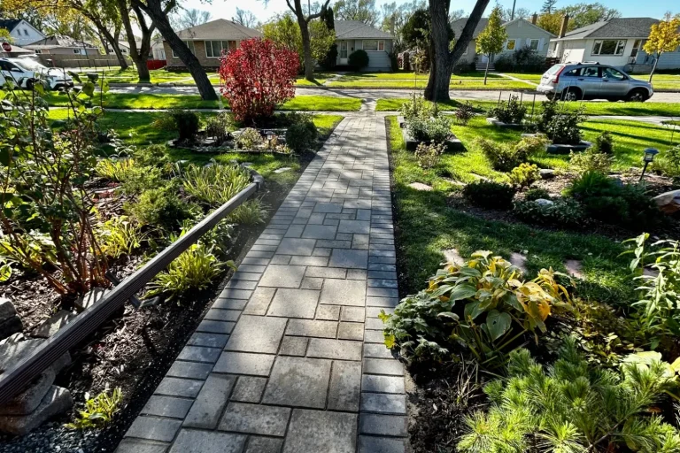 Barkman Verano paver front sidewalk with perennial gardens throughout completed by Genesis Interlocking & Custom Landscaping 