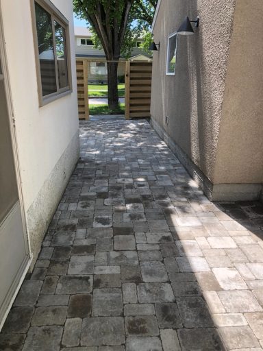 Barkman Roman paver patio in natural grey completed by Genesis Interlocking & Custom Landscaping