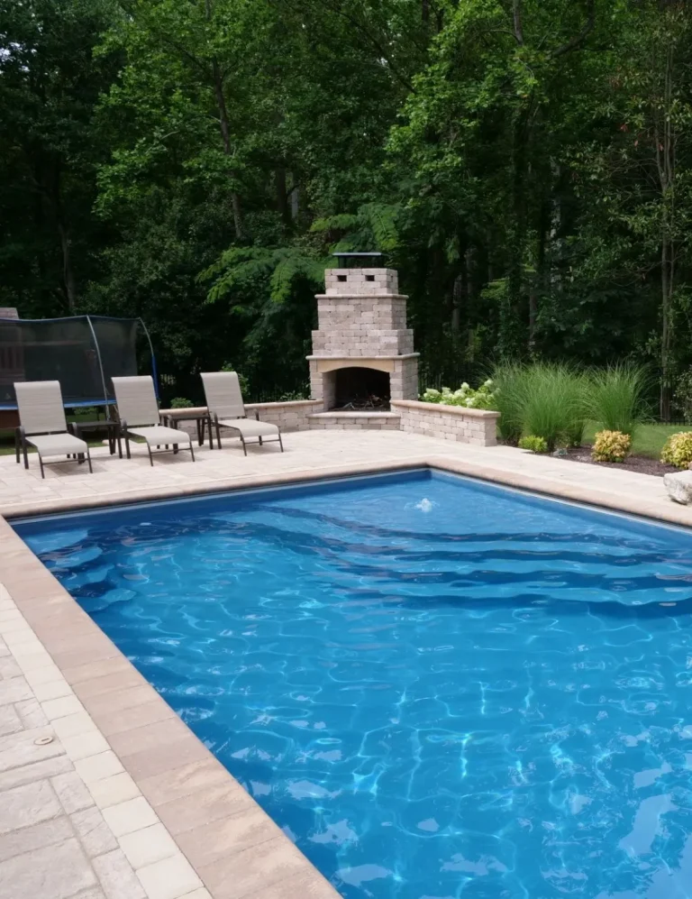 Fiberglass swimming pool with custom fire place, seating wall & interlocking patio