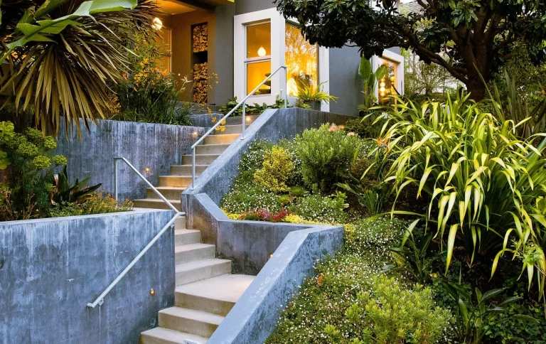 Front entrance retaining walls, steps & railings with tropical landscaping 
