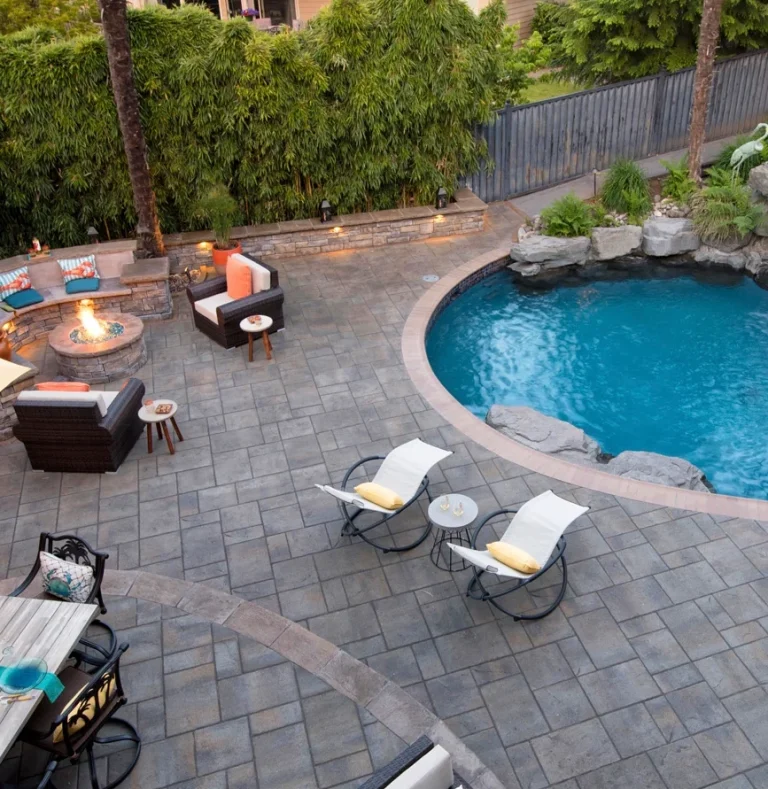 Inground swimming pool with interlocking paving stone pool decking 