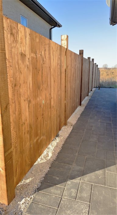 Pressure treated 6x6 fence and sidewalk completed by Genesis Interlocking & Custom Landscaping