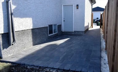 Barkman Broadway paver patio in charcoal completed by Genesis Interlocking & Custom Landscaping