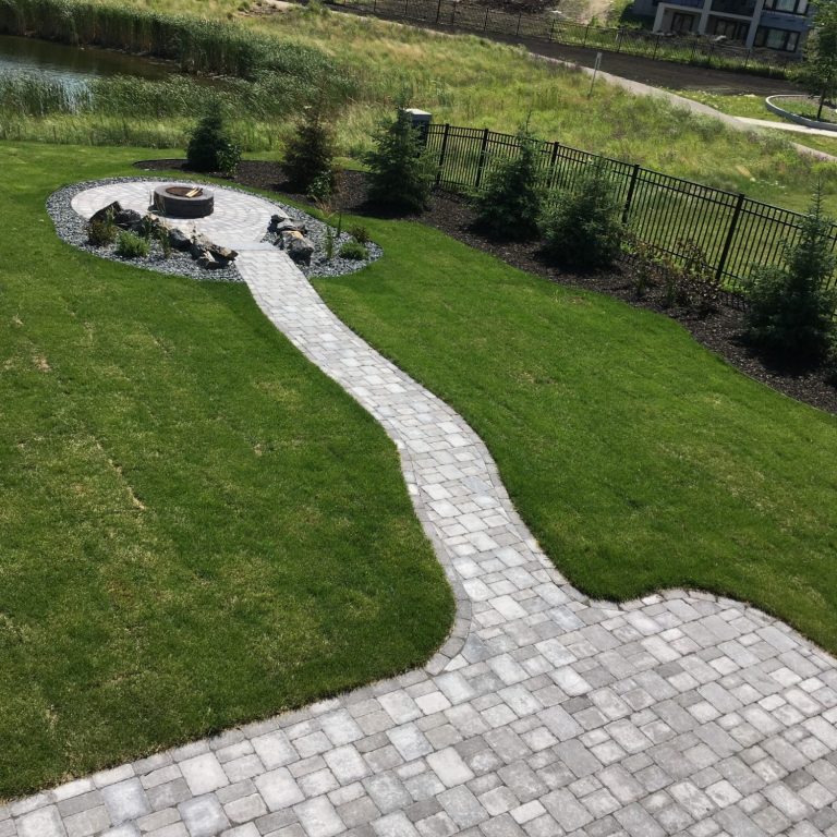 Barkman Roman paver patio and sidewalk leading to sunken fire pit completed by Genesis Interlocking & Custom Landscaping - Winnipeg Hardscaping 