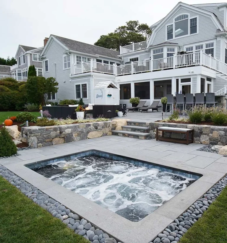 Fiberglass swimming pool with rustic landscaping, outdoor bar & entertaining space