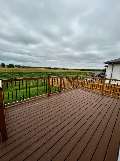 Composite decking with wood and aluminum railings completed by Genesis Interlocking & Custom Landscaping
