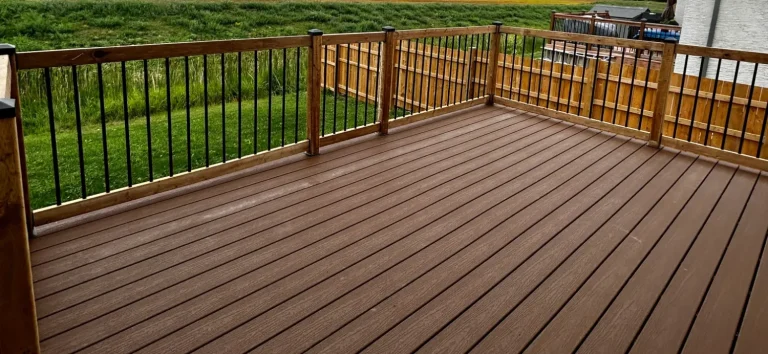 Composite deck with pressure treated railing completed by Genesis Interlocking & Custom Landscaping