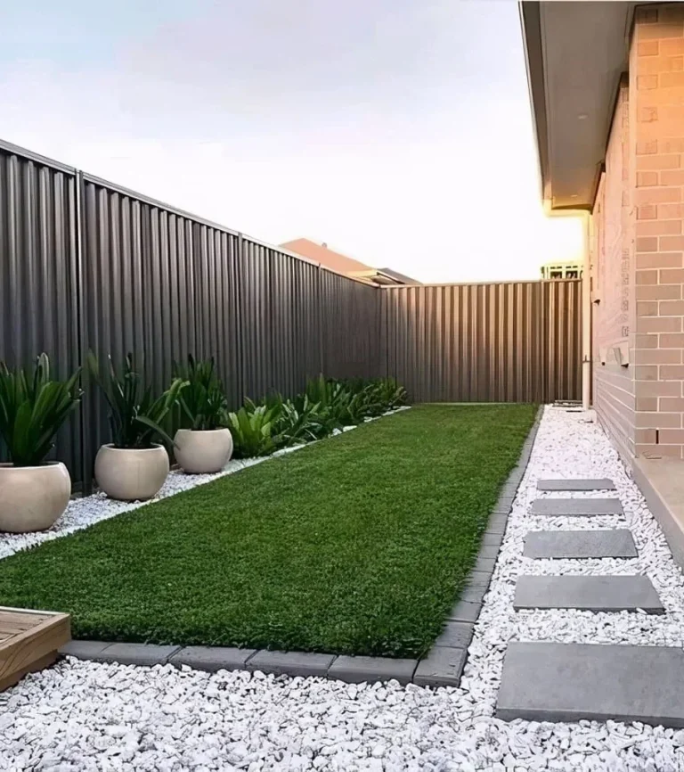 Low maintenance backyard artificial turf with stepping stones and rock
