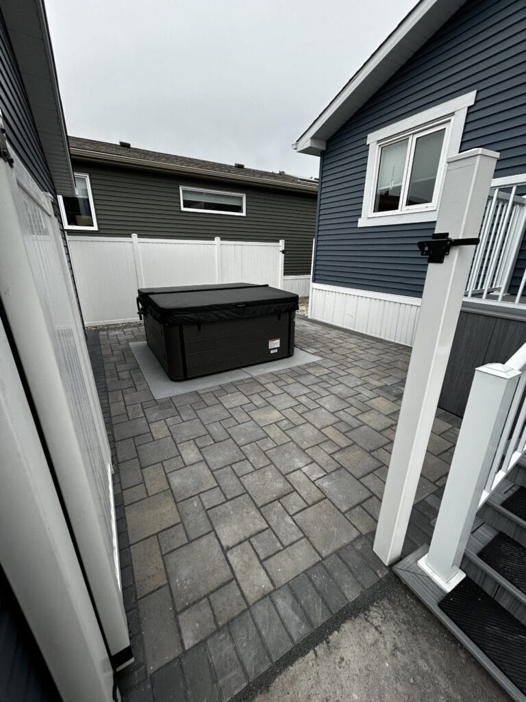 Interlocking paver patio and vinyl fence installed in Winnipeg Manitoba by Genesis Interlocking & Custom Landscaping